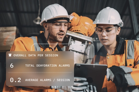 Workers reviewing dehydration alarm data on tablet.