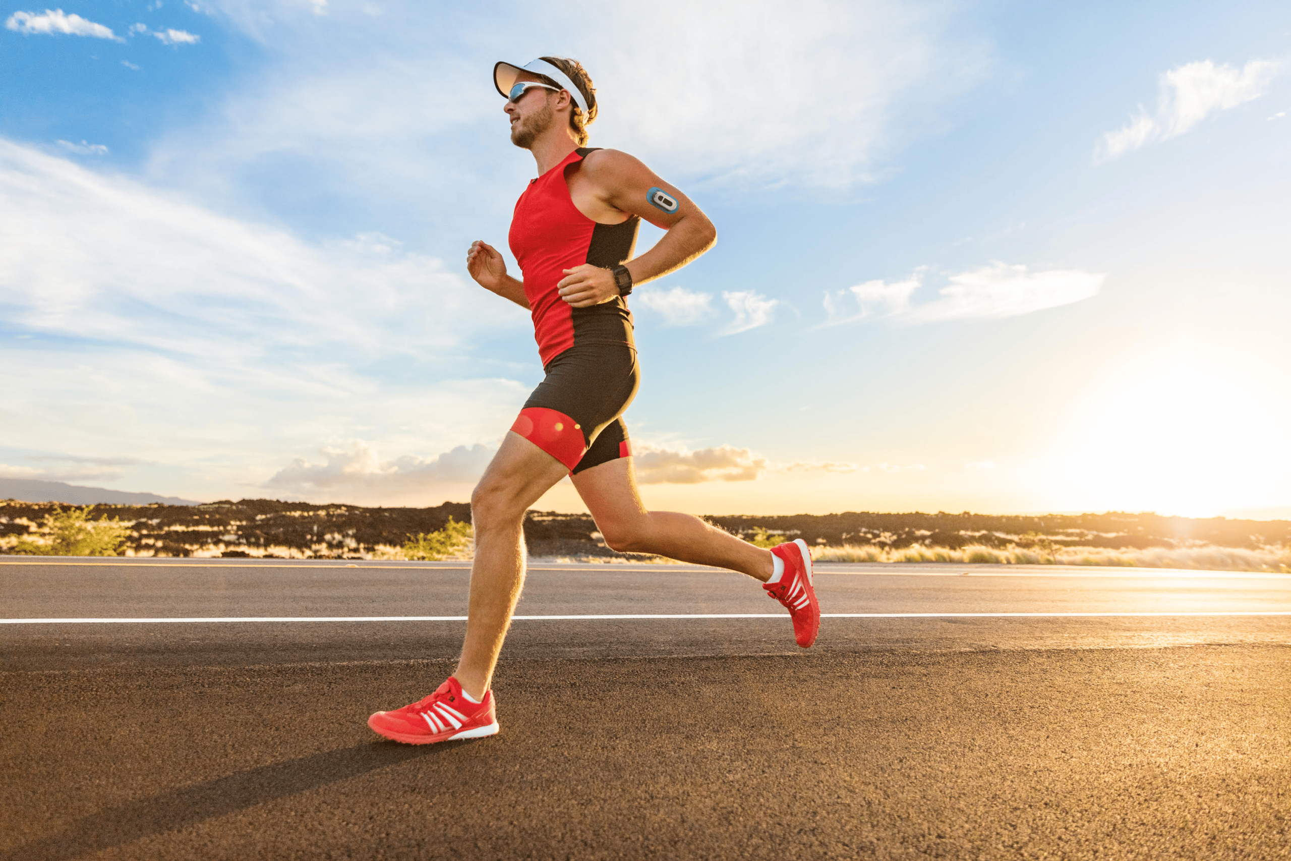 Athlete running with wearable hydration sensor on arm