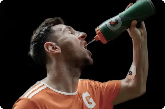 Athlete drinking water with Gx patch on arm